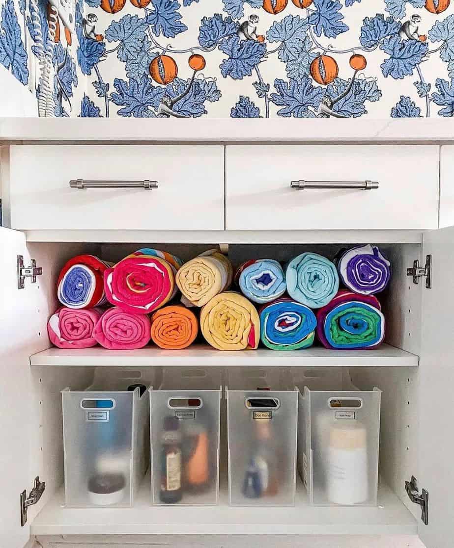 rolled up towels on a shelf