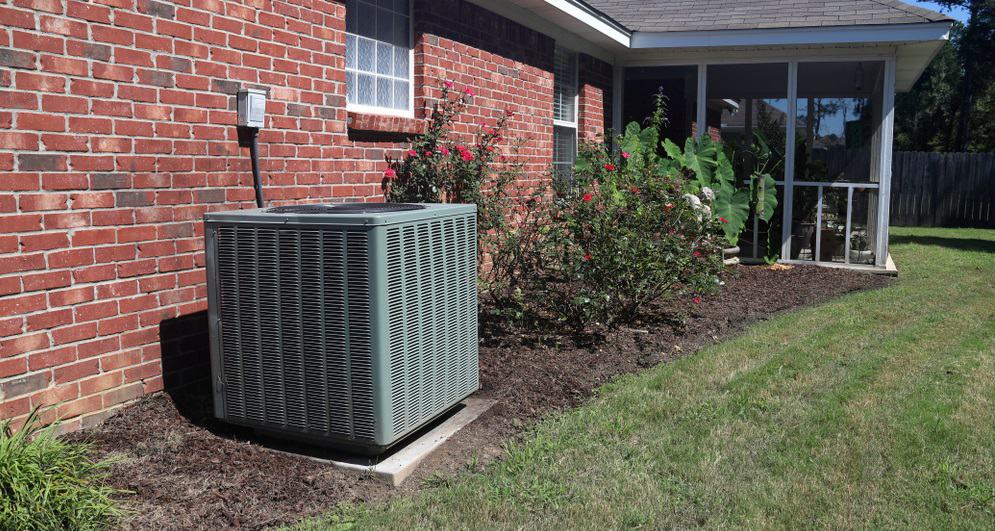 Air Conditioner system next to a home
