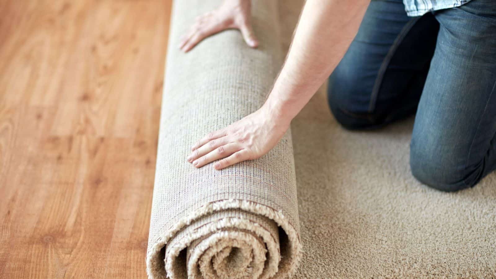 a person rolling a carpet