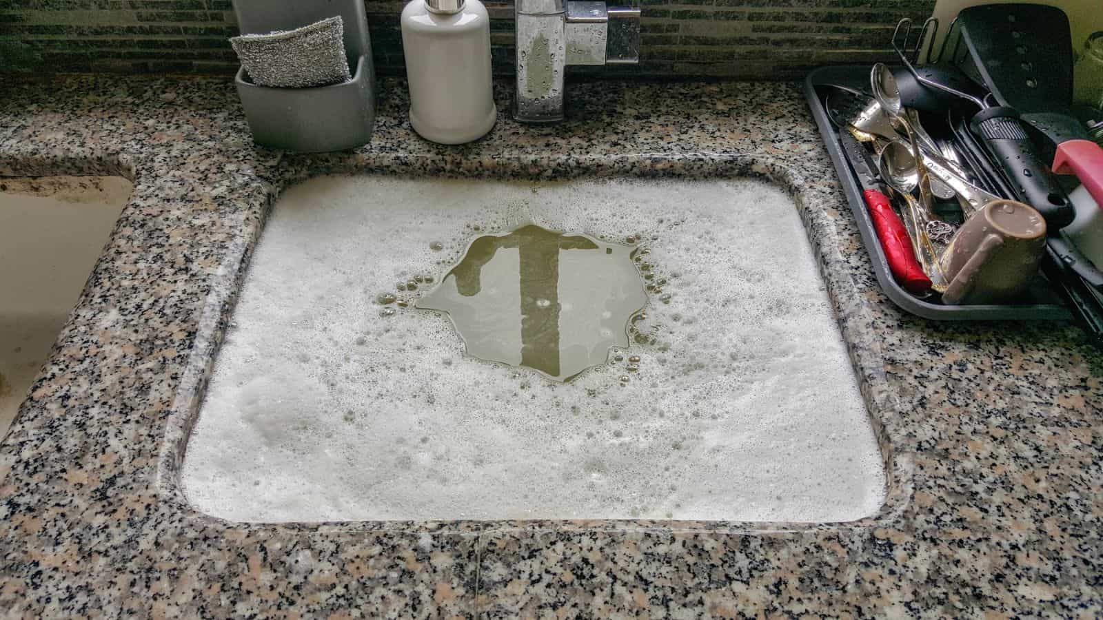 Overflowing kitchen sink, clogged drain