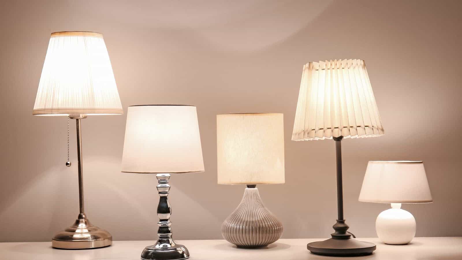 Glowing mid-century modern lamps on table in evening