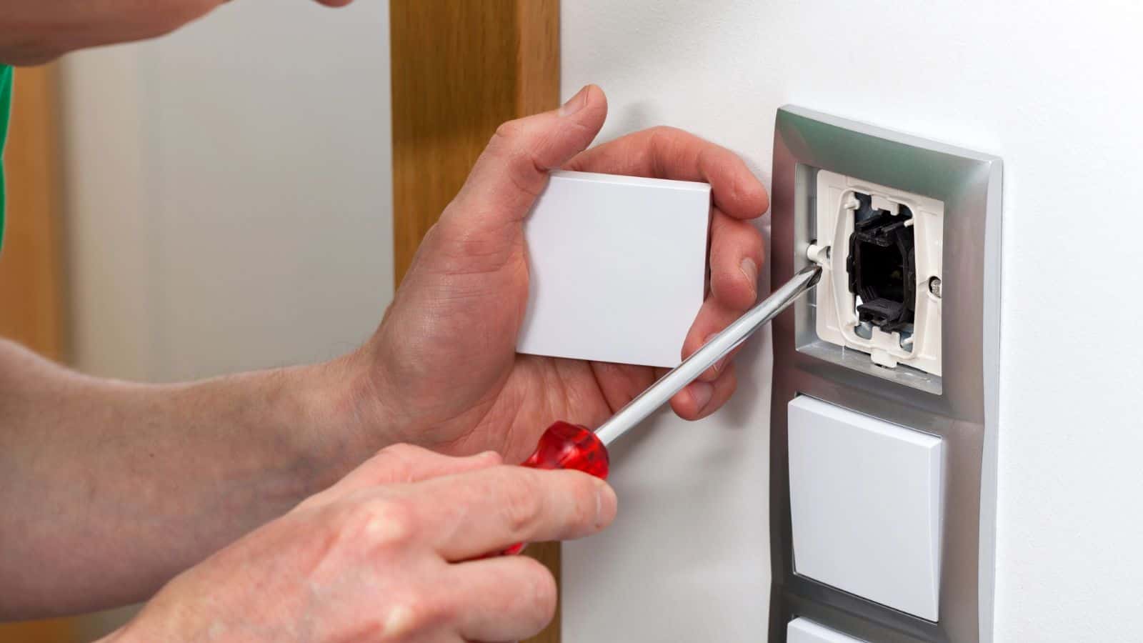 Man fixing the light switch